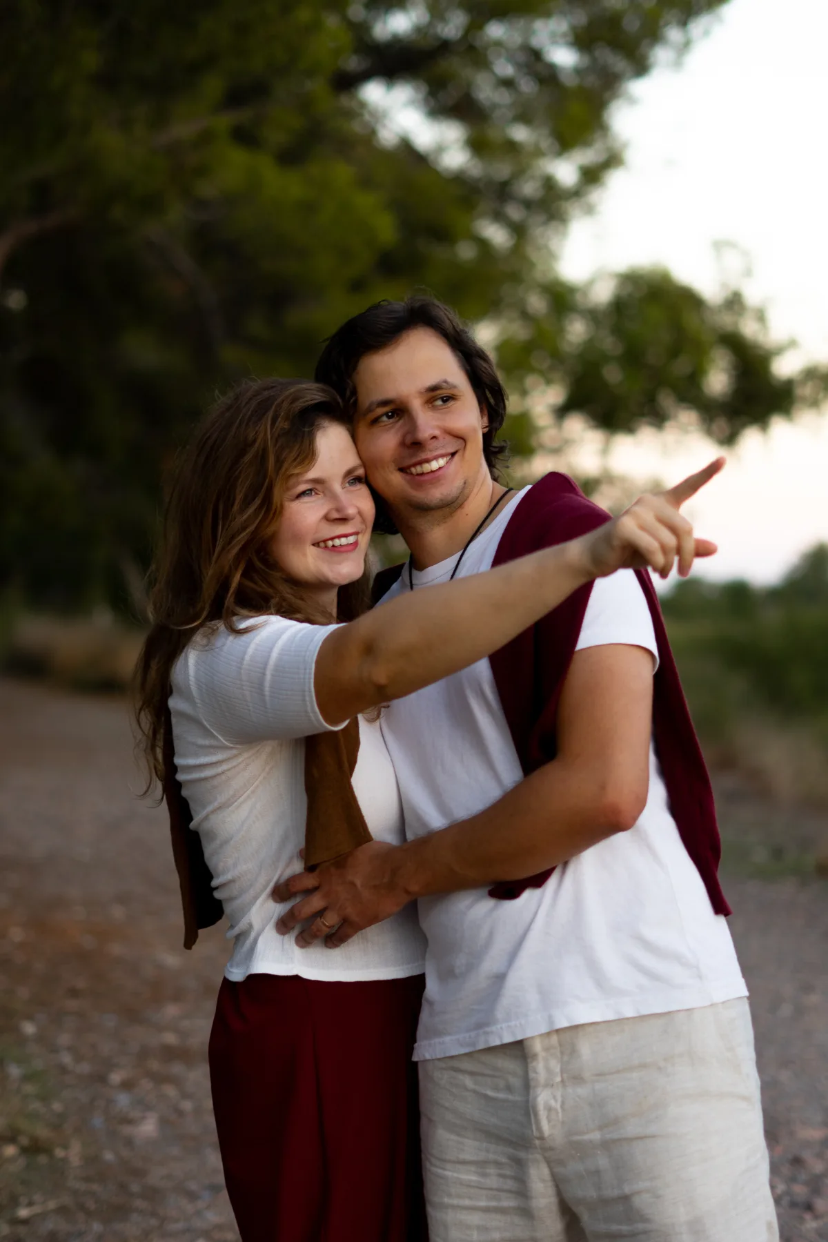 Two members of the family embracing outdoors.